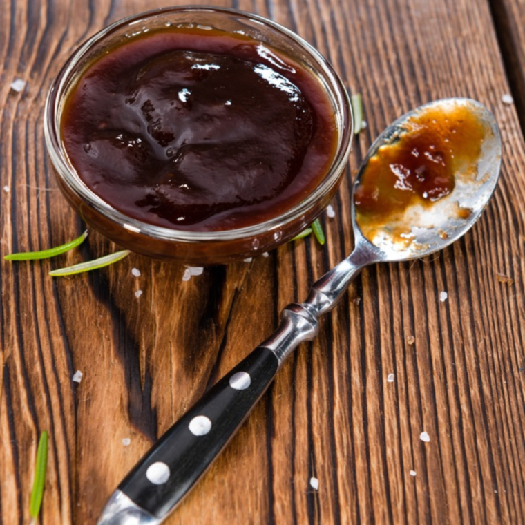 Homemade Wendy’s BBQ Sauce in a small bowl with fries and nuggets for dipping.