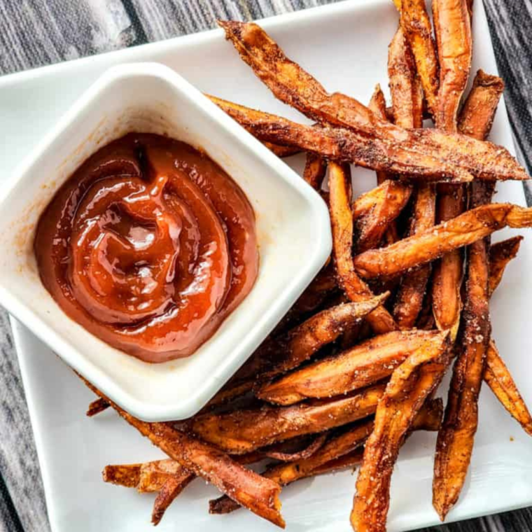 A bowl of homemade Wendy’s BBQ Sauce surrounded by fresh ingredients like ketchup, honey, and spices.