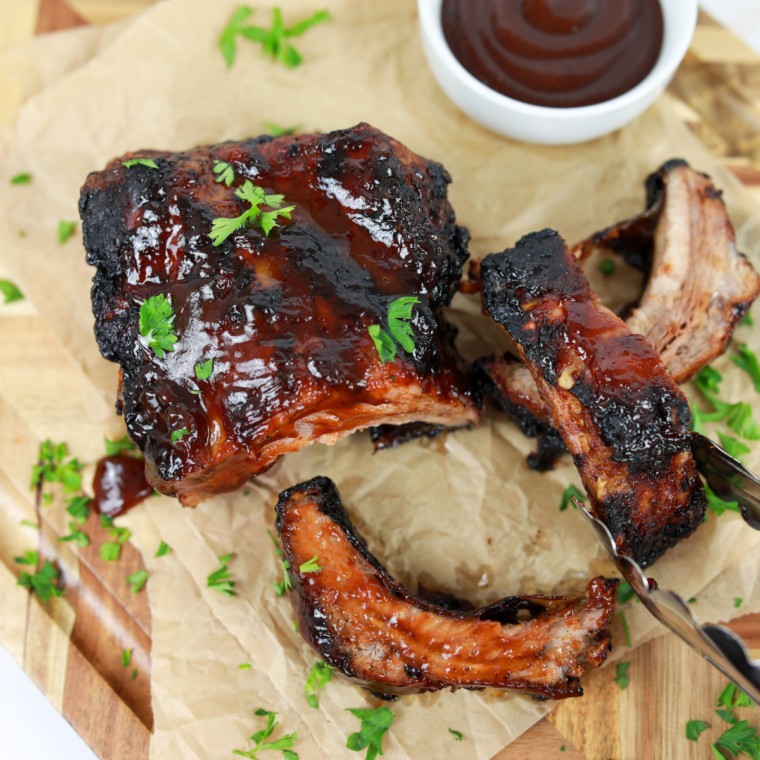 Small bowl of homemade Wendy’s BBQ Sauce surrounded by dipping fries and nuggets."