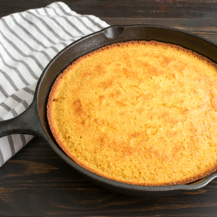 "Golden, fluffy White Lily Cornbread served in a cast-iron skillet with a slice cut out, ready to be enjoyed."