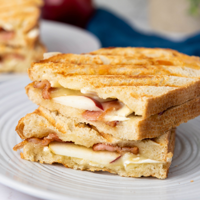 A close-up of a 15-Minute Apple Brie Sandwich with layers of creamy brie, crisp apple slices, and toasted bread.