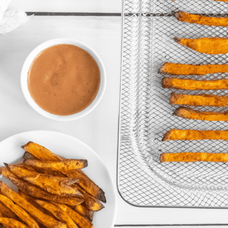 A bowl of creamy, homemade A&W Spicy Chipotle Dipping Sauce served alongside a pile of crispy, golden fries.