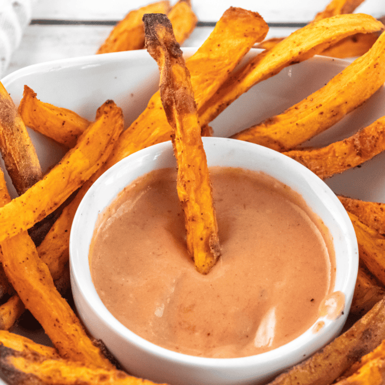 A bowl of homemade A&W Spicy Chipotle Dipping Sauce served with crispy fries for dipping.