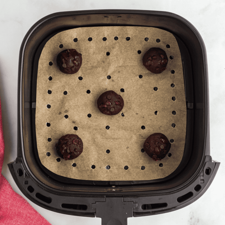 Top cookie dough with reserved cherries and chocolate chips, then freeze for 15 minutes to prevent spreading.
