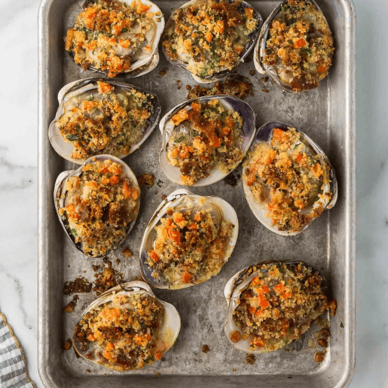 Topped clams placed in the air fryer basket, ready to be cooked at 375°F for 6–8 minutes until the topping is golden brown and crispy.