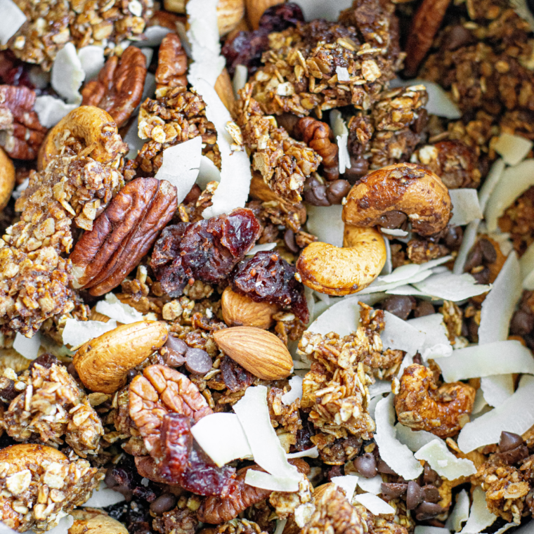 Close-up of freshly made Air Fryer Protein Granola with oats, nuts, and dried fruit served in a bowl.