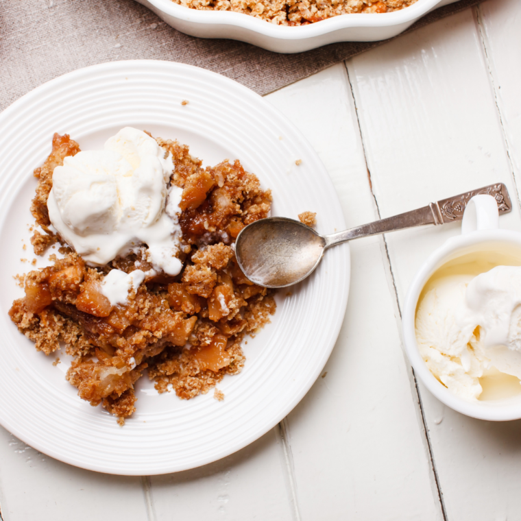 A close-up of homemade Air Fryer Granola without coconut oil, perfectly golden and crunchy, served in a white bowl.