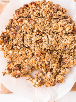 A bowl of golden Air Fryer Granola made without coconut oil, served with fresh fruit and yogurt.