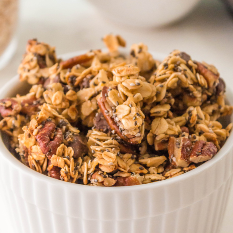  Air fryer granola without coconut oil, featuring oats, nuts, and maple syrup for a crunchy, healthy treat.