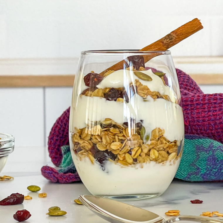 A bowl of homemade Air Fryer Granola made without coconut oil, featuring oats, nuts, and a golden, crunchy texture.