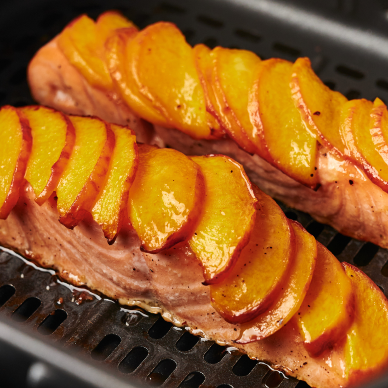 Once cooked, remove the salmon from the air fryer and drizzle any remaining peach glaze over the top before serving.