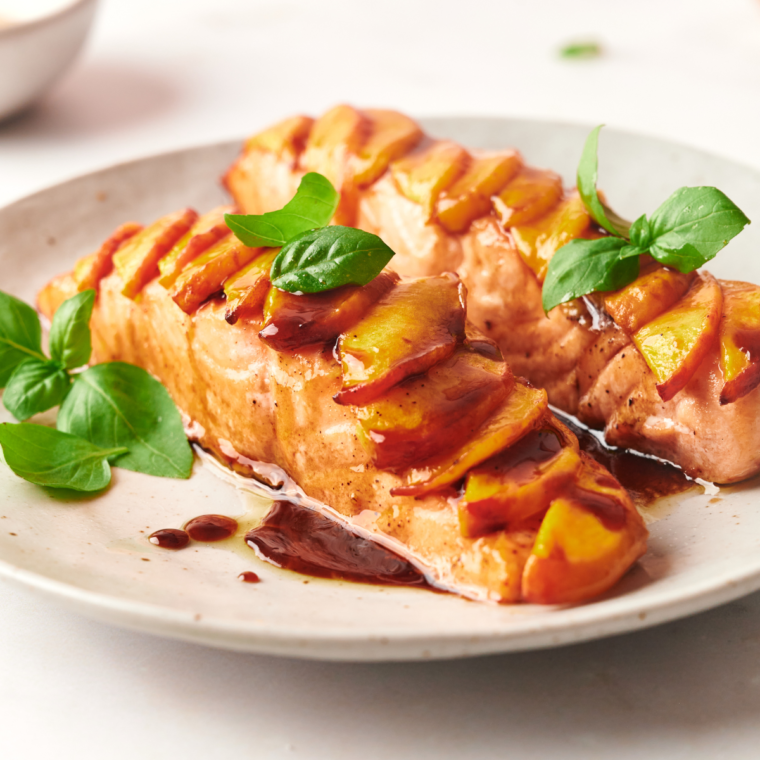 Air Fryer Peach Salmon topped with fresh peach slices and a sweet peach glaze, ready to serve.