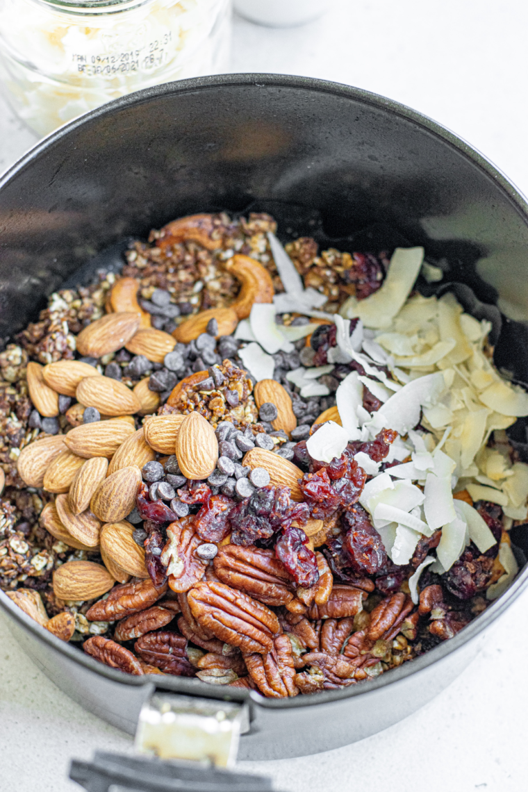 A bowl of golden, crunchy Air Fryer Protein Granola served with yogurt and fresh berries, a nutritious and delicious breakfast or snack option.