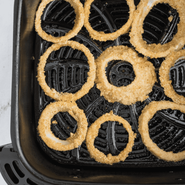 "Preheating air fryer and arranging onion rings in the basket for crisping at 375°F (190°C) for 8-10 minutes."