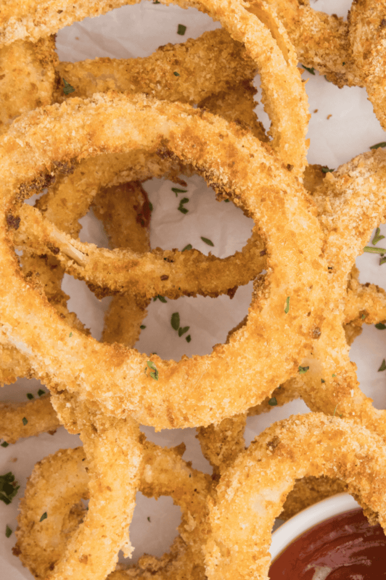 Crispy Applebee's Onion Rings Copycat Recipe, air-fried to golden brown and served with dipping sauce.