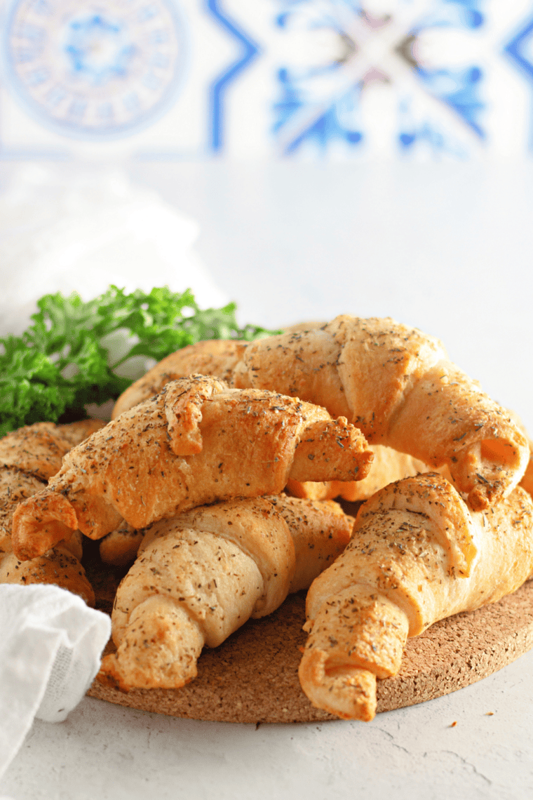 Finished Croissants with Honey Butter: "Golden croissants drizzled with a sweet honey butter glaze, ready to serve."