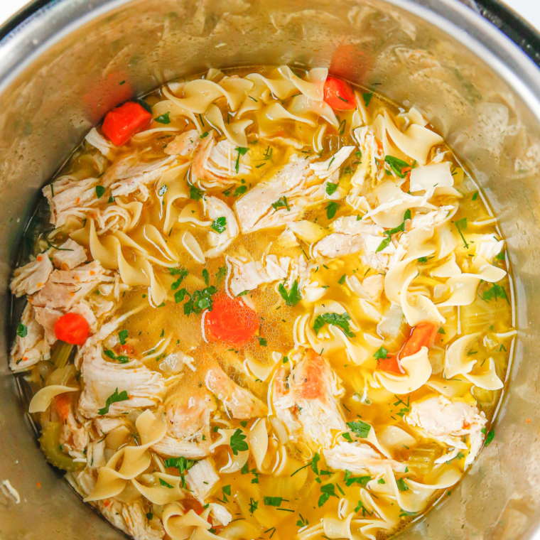 Adding chicken broth, salt, pepper, and thyme to the pot, followed by cooking egg noodles and combining shredded chicken for a flavorful, simmering chicken noodle soup.