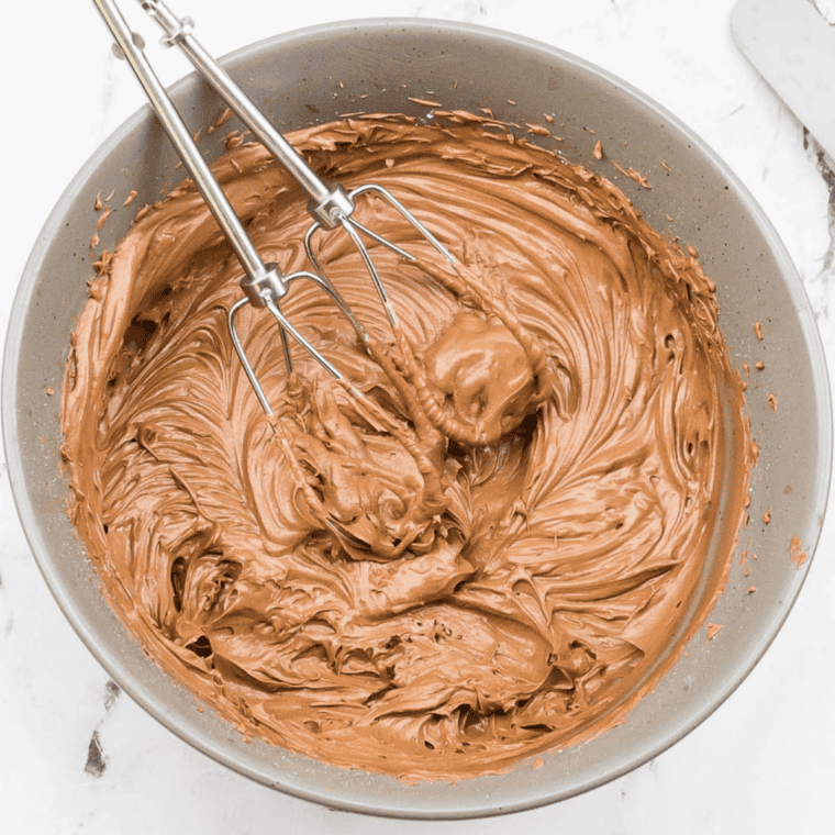 Mixing wet ingredients into dry ingredients to make a smooth batter for Copycat Portillo’s Chocolate Cake.