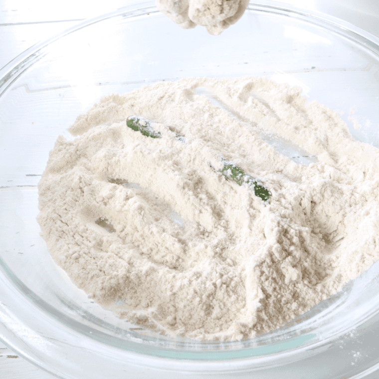 Whisk together the all-purpose flour, cornstarch, baking powder, salt, pepper, and garlic powder in a bowl to create the crispy coating for the green beans