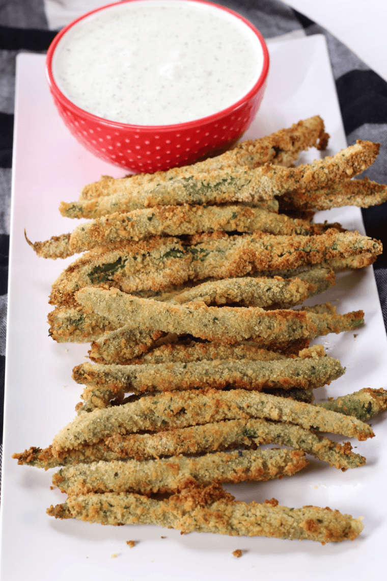 Crispy green beans in a basket with golden, crunchy coating, served as a PF Chang’s copycat appetizer.