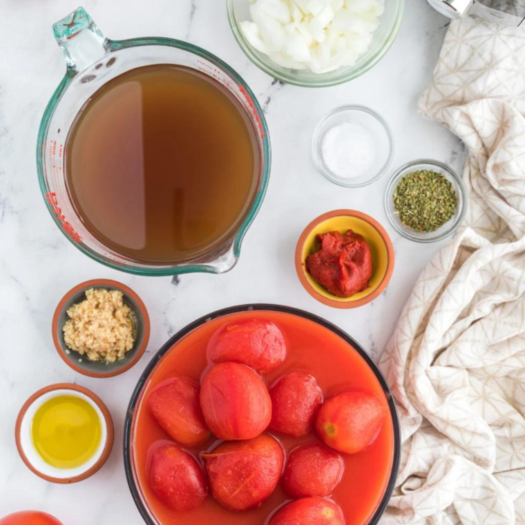 Ingredients needed for Dairy Free Tomato Basil Soup on kitchen table.