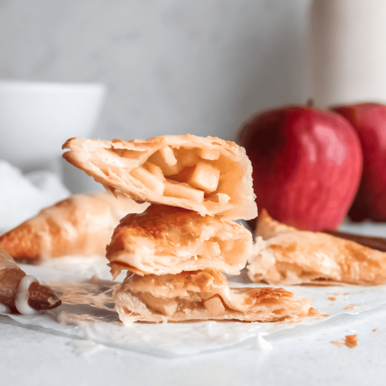 Homemade Hardee’s-style apple turnovers with golden, flaky crust and a glossy glaze, served on a white plate.