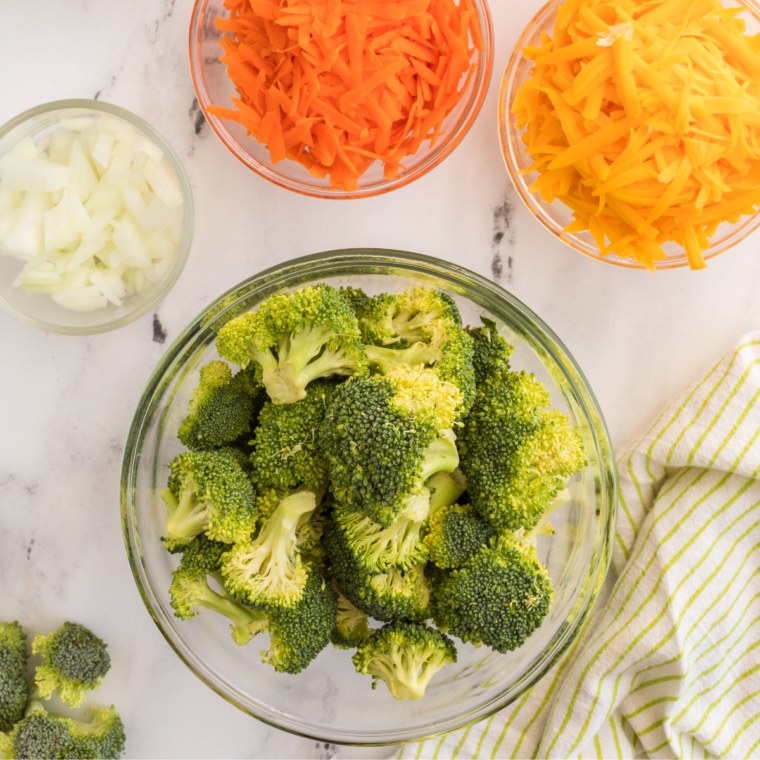 Fresh broccoli being washed and trimmed into bite-sized florets, ready for cooking.