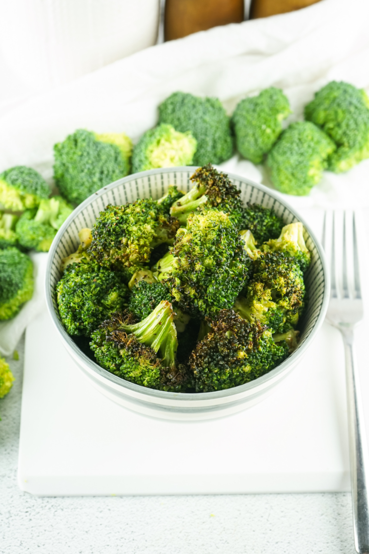 Steamed Longhorn Steakhouse-style broccoli served on a plate, perfectly tender and seasoned with butter and spices for a flavorful side dish.