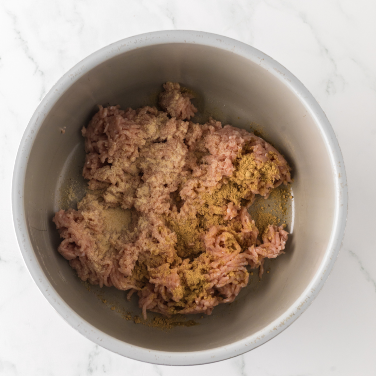 Step-by-step process of cooking ground chicken, garlic, ginger, and cabbage in the Ninja Foodi for Chicken Egg Roll Bowls.