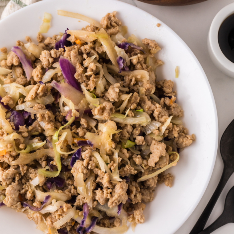 A plate of Ninja Foodi Chicken Egg Roll Bowls, showcasing a savory mixture of ground chicken, cabbage, and flavorful seasonings.