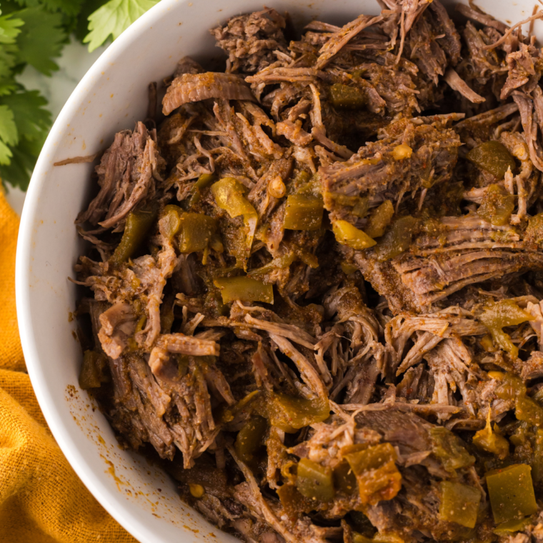 Shred the roast and combine the shredded beef with a cup of juice from the Ninja Foodi in a bowl.