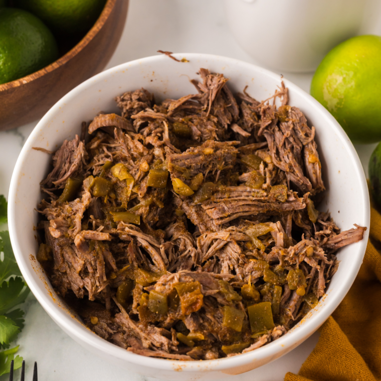 Tender shredded barbacoa beef cooked in the Ninja Foodi, ready to be served in tacos or burritos.