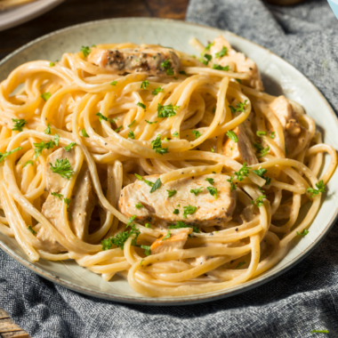 A bowl of Olive Garden-style Garlic Herb Sauce, creamy and flavorful, perfect for pairing with pasta, breadsticks, or as a dipping sauce.