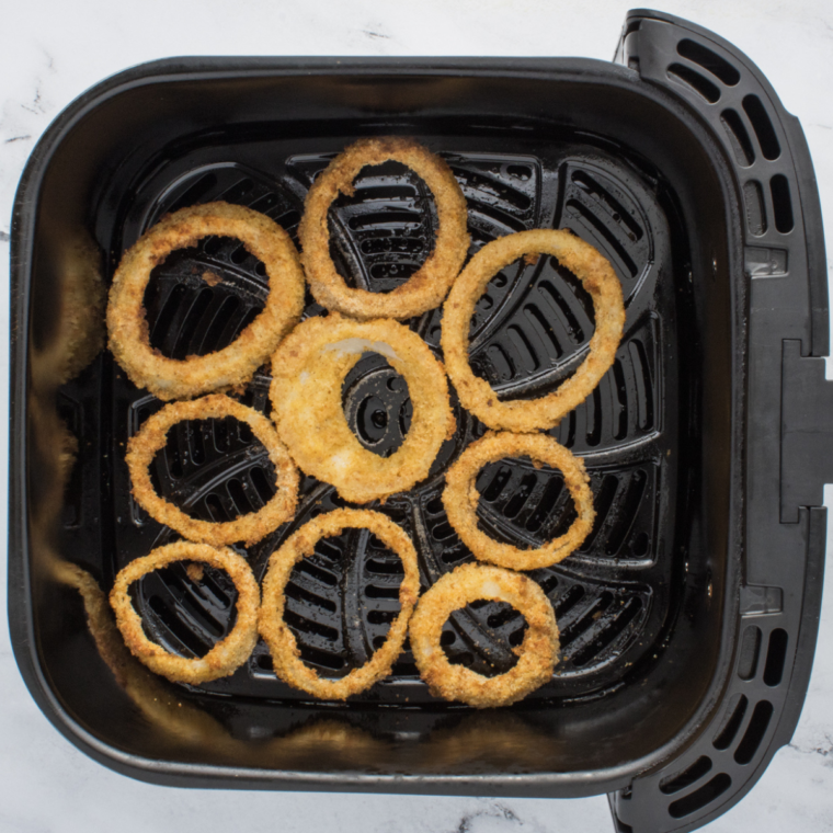 Frying onion rings in hot oil until golden brown, or air frying them at 375°F, flipping halfway for even cooking.