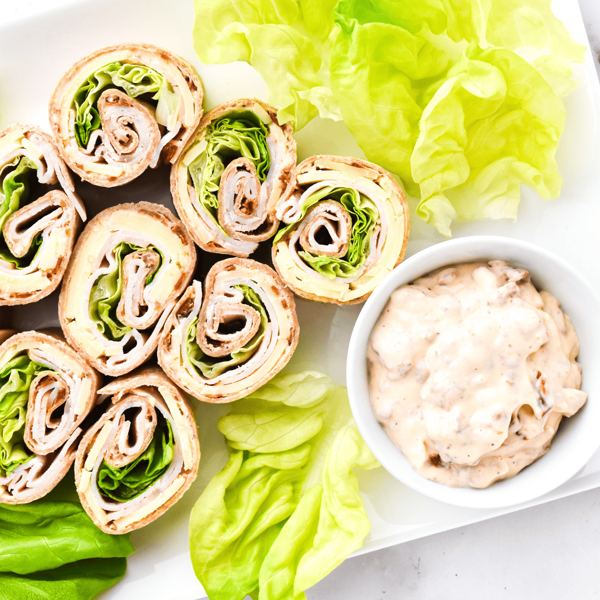 Sun-dried tomato spread made with cream cheese, mayonnaise, and spices in a small bowl.