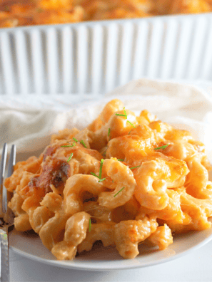 "Dish of creamy Texas Roadhouse-style macaroni and cheese, topped with a sprinkle of cheese and served in a bowl."