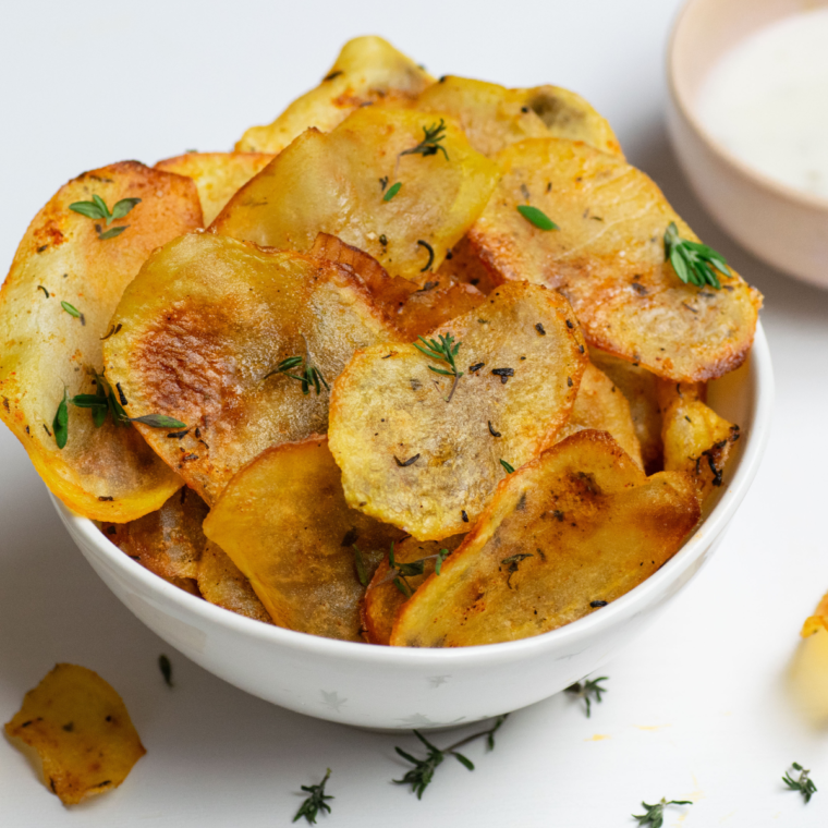 Homemade Air Fryer All Dressed Potato Chips seasoned with a tangy-sweet blend, served in a bowl.