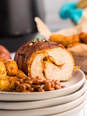 Air fryer bacon wrapped chicken breast with crispy golden bacon and tender chicken inside.