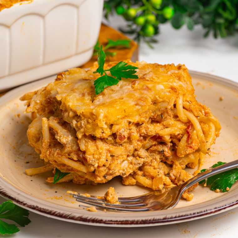 Air Fryer Baked Spaghetti served in a dish with melted cheese on top.