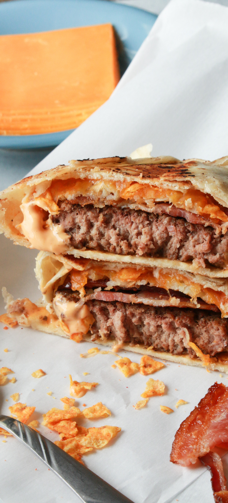  Air Fryer Cheeseburger Crunch Wrap filled with burger patties, crispy bacon, cheese, tater tots, and Doritos wrapped in a golden, crispy tortilla.