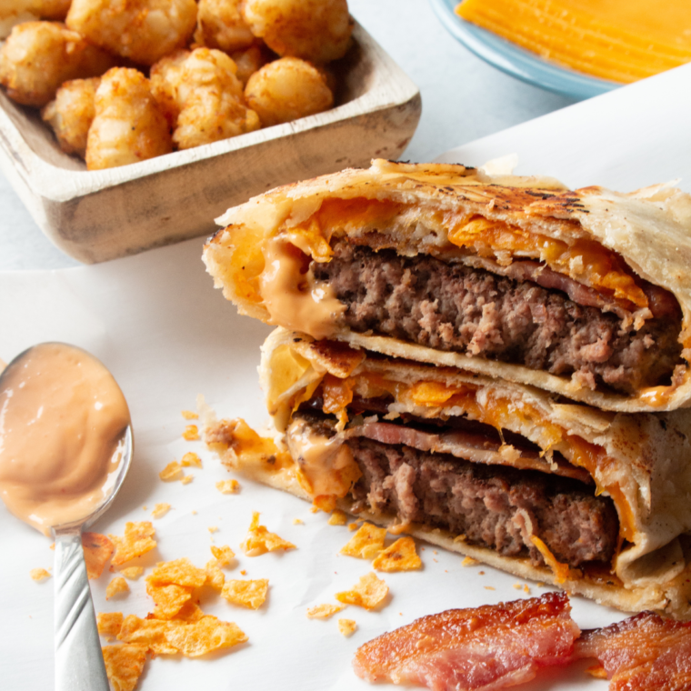 Crispy Air Fryer Cheeseburger Crunch Wrap stuffed with juicy cheeseburger patties, melted cheese, fresh lettuce, tomatoes, and a golden tortilla shell.