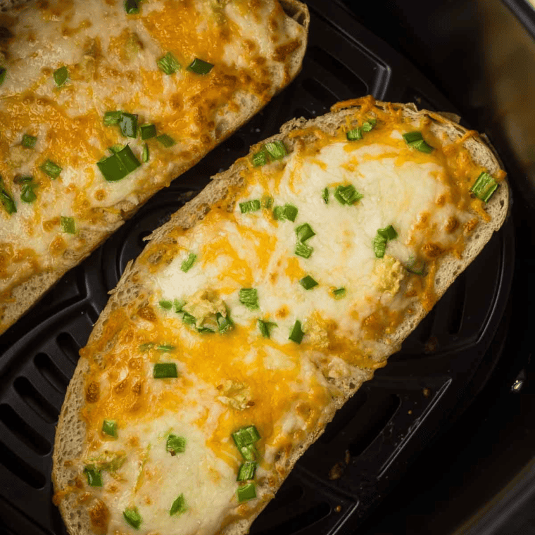 The crispy air fried chili cheese toast with salty peppers and melted cheese on it.