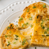 Air Fryer Chili Cheese Toast with crispy bread topped with chili and gooey melted cheese, ready for a satisfying bite.