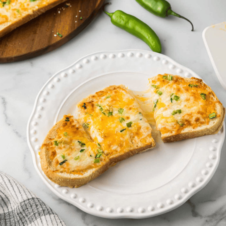 Air fried chili cheese toast and melted Marri -La cheese, Cherda cheese and Saraino pepper on crispy acid dough.