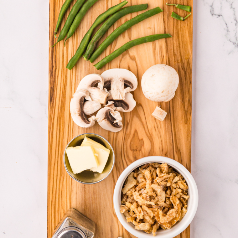 Ingredients needed for Air Fryer Green Beans with Mushrooms and Onion on kitchen table.