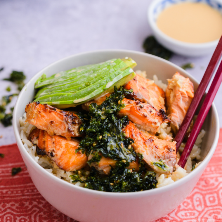 Air Fryer Salmon Bowl with crispy salmon, fresh vegetables, avocado, and a savory sauce, served in a bowl for a nutritious meal.