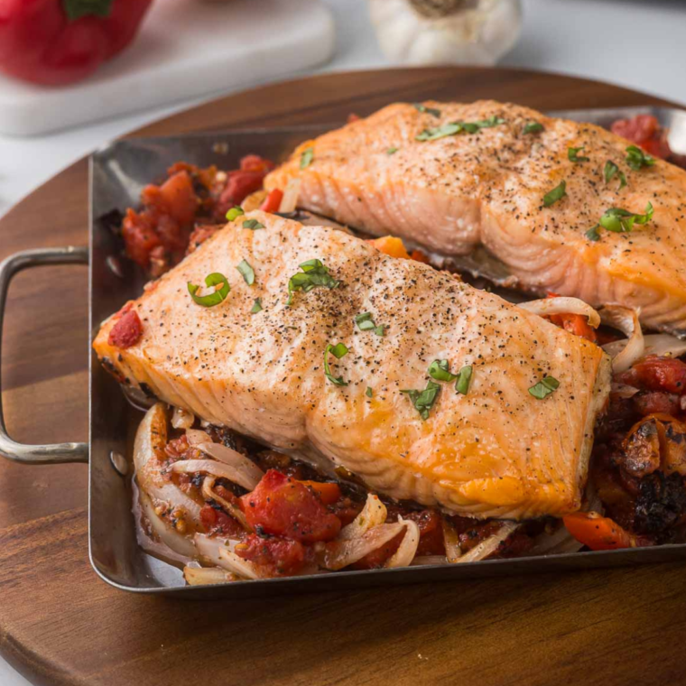 Air Fryer Salmon Cacciatore served with bell peppers, onions, and a fresh basil garnish.