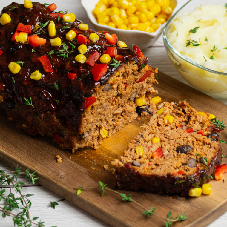 Southwest meatloaf topped with a spicy ketchup glaze in an air fryer, cooked to 160°F and resting before slicing.