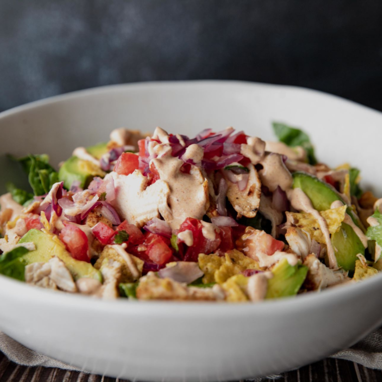 Chicken Tikka Salad with marinated chicken, fresh vegetables, and a tangy dressing served in a bowl.