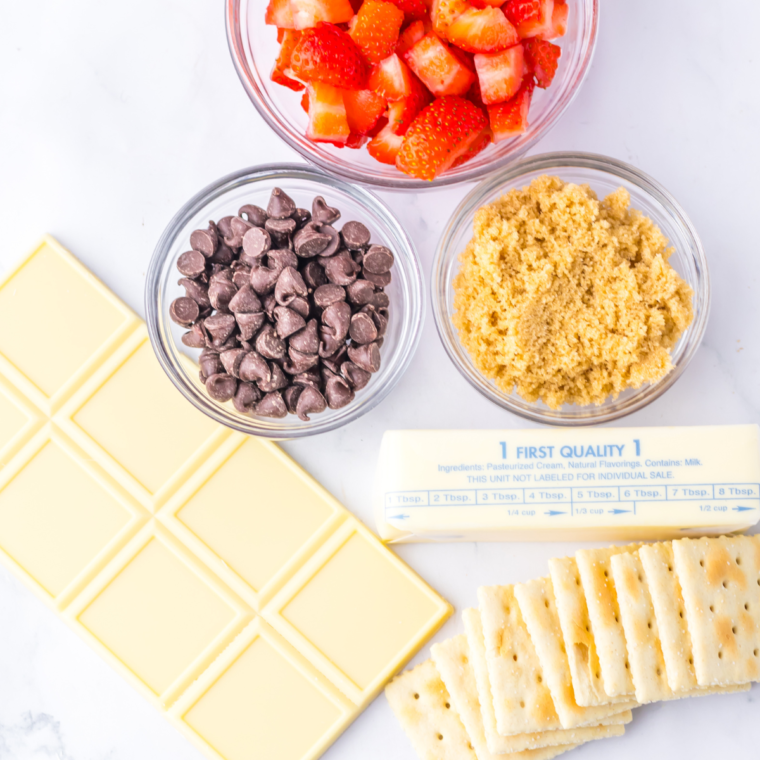 Ingredients needed for Chocolate Covered Strawberry Bark on kitchen table.